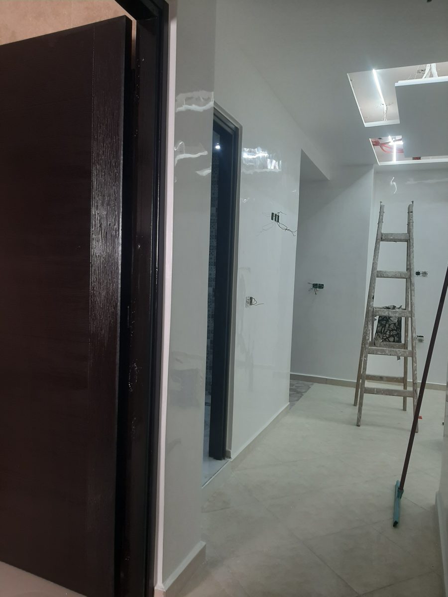 Couloir aux murs laqués brillants en cours de finition
