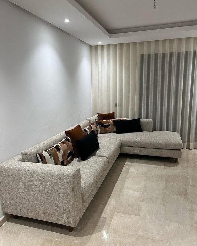 Canapé d'angle contemporain en tissu beige-gris avec coussins