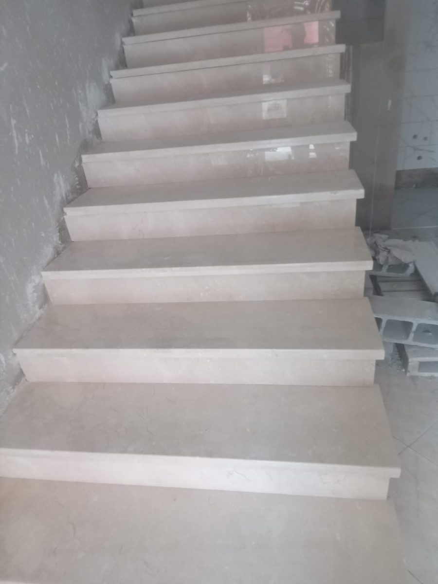 Escalier en grès effet marbre blanc veiné à garde-corps noir