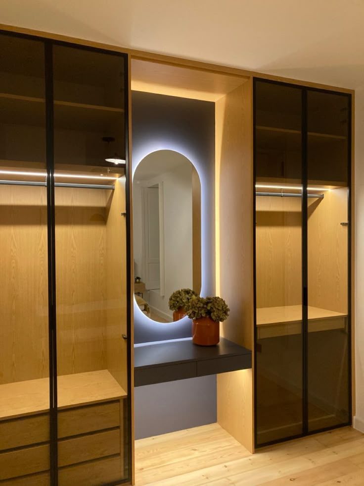 Dressing à portes vitrées noires et coiffeuse à miroir rétro-éclairé