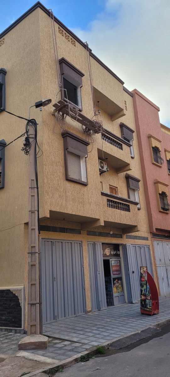 Façade d'immeuble à crépi beige à balcons