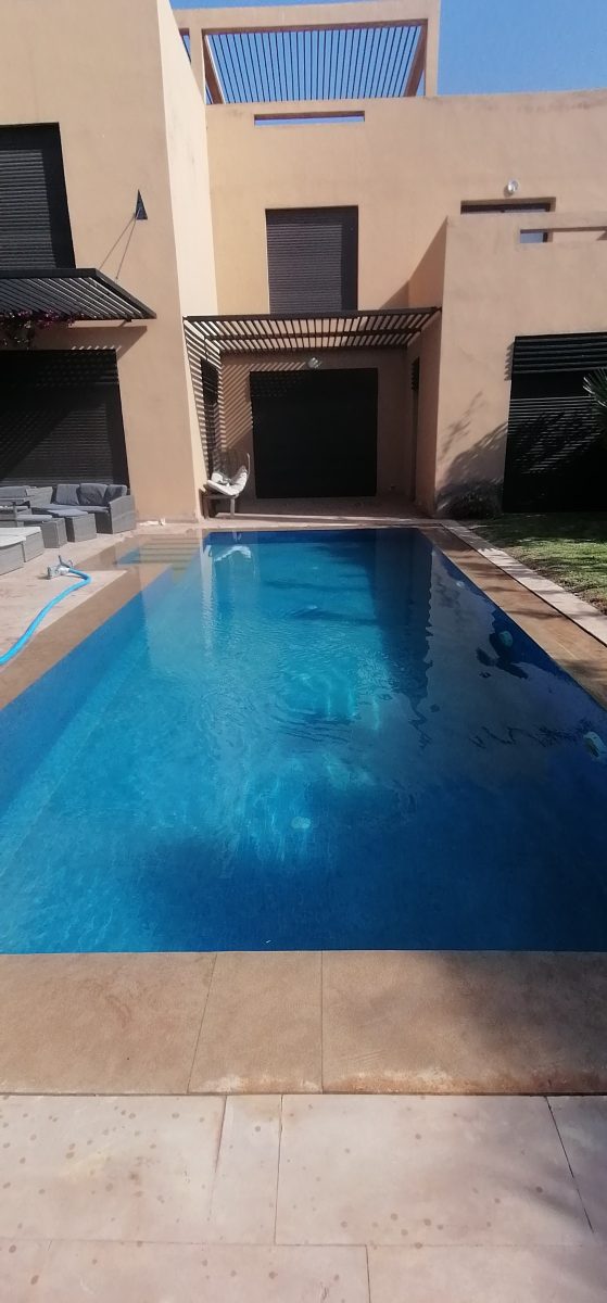 Piscine rectangulaire à liner bleu foncé et pergola bois
