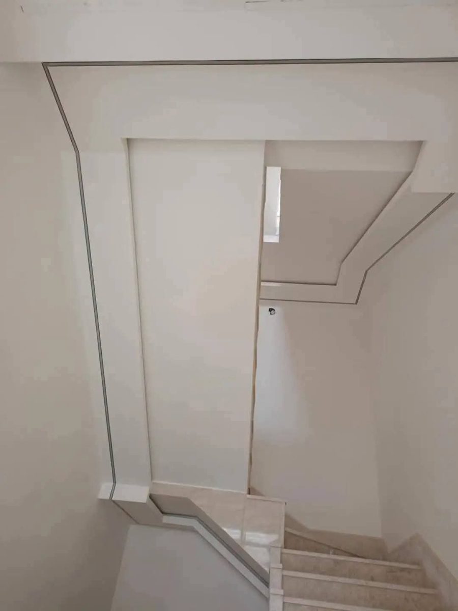 Cage d'escalier en plâtre à retombées et corniches, en cours