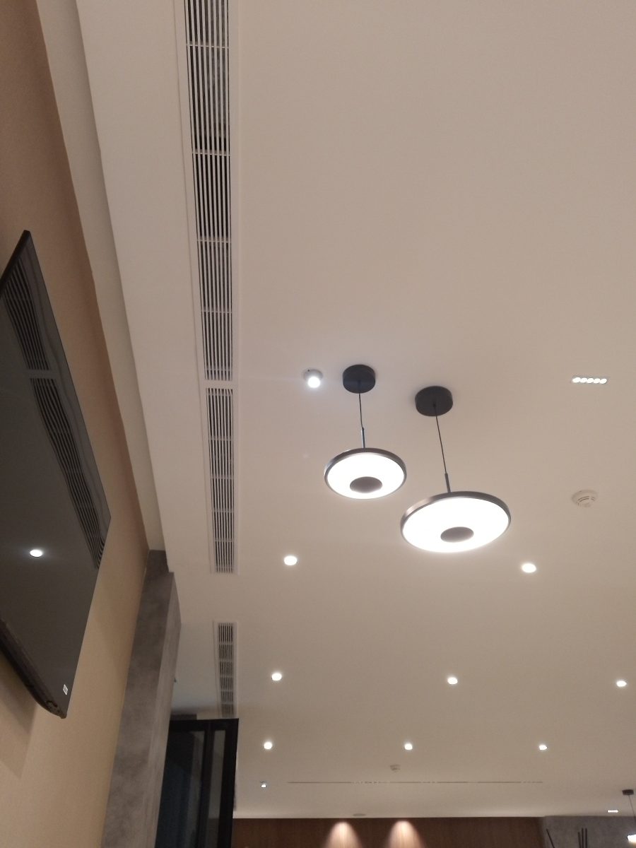 Faux plafond à suspensions LED et bouche de climatisation