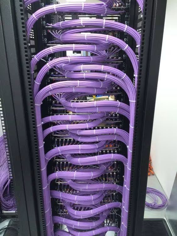 Baie informatique au câblage violet en boucles régulières