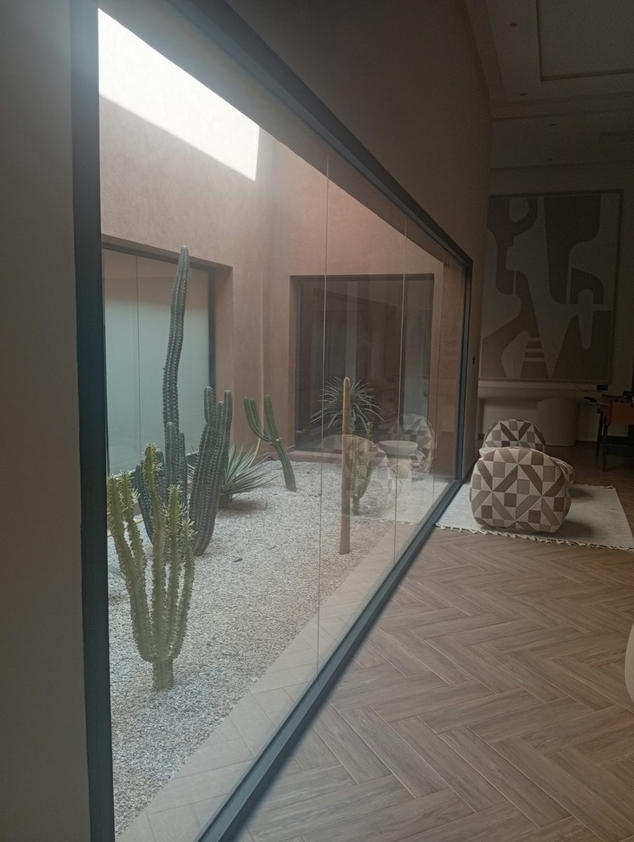 Baie vitrée en aluminium sur un patio minéral