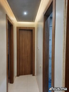 Couloir à portes en bois de noyer et faux plafond à gorge LED — Agadir