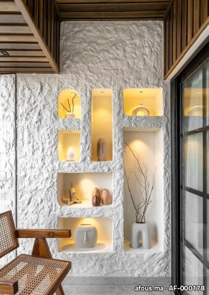 Mur en enduit blanc à niches rétro-éclairées à vases