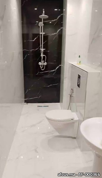 Salle de bain effet marbre blanc et noir à WC suspendu