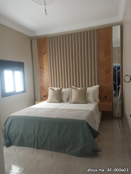 Chambre à tête de lit capitonnée et panneaux bois — Marrakech